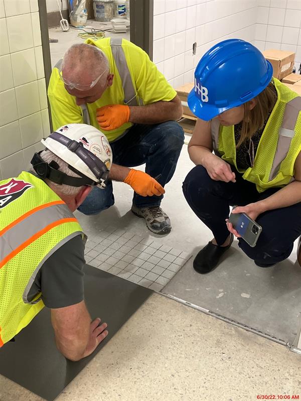 Flooring contractor, construction manager, and architect collaborating on flooring detail 